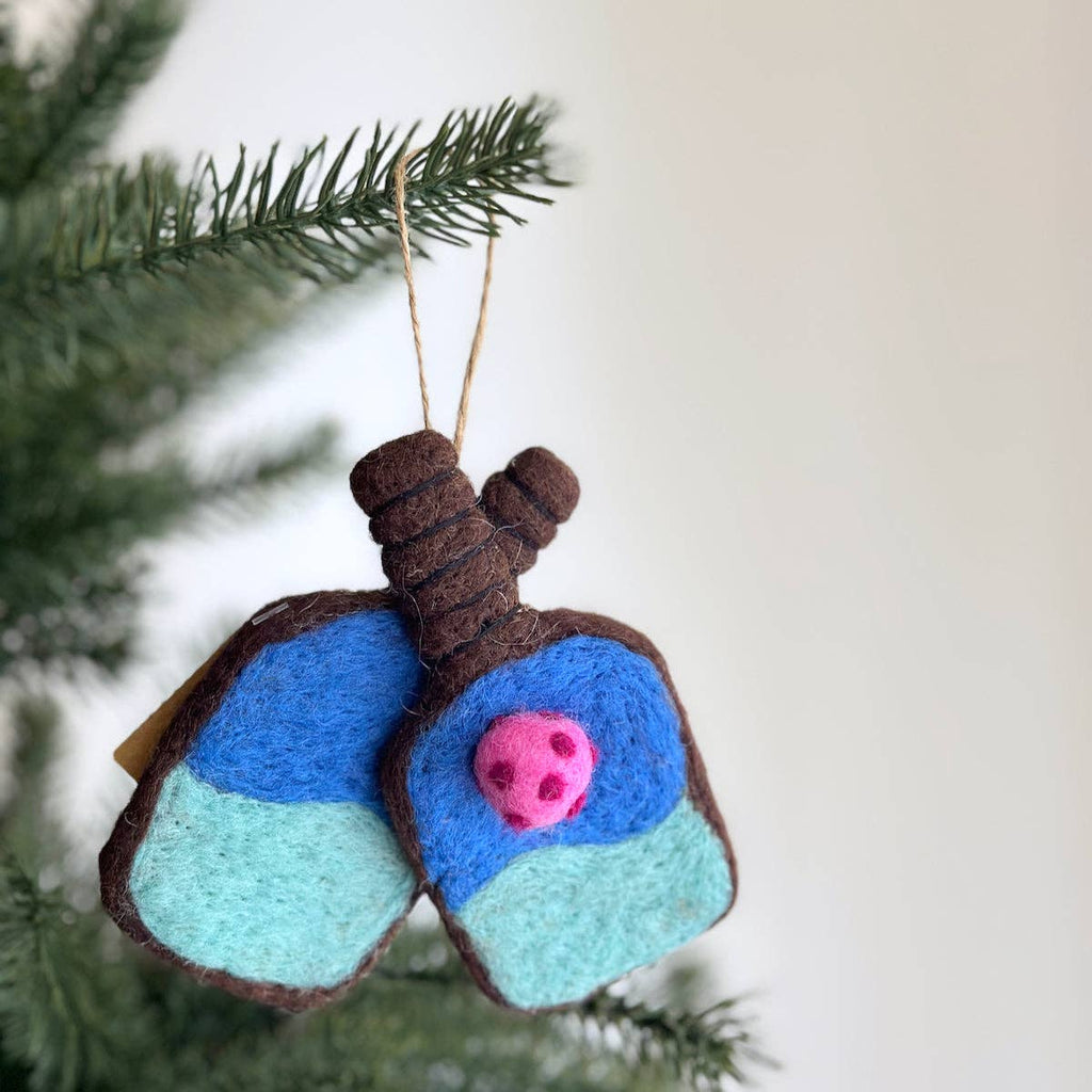 Add a touch of fun to your holiday decor with our Felt Pickleball Ornament! Handcrafted using needle felting techniques, this charming ornament captures the essence of the popular sport. With intricate detailing and vibrant colors, it's sure to delight pickleball enthusiasts. Hang it with the included twine thread for an adorable addition to your tree or gift it to a pickleball lover for a unique and playful present! Material: 100% wool, jute thread; Azo-free dyes. Size: 5" x 6" x 1"