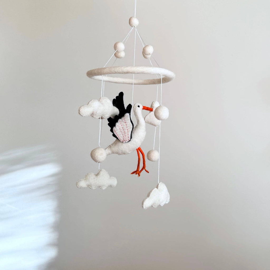 Elevate your nursery with our Felt Stork Baby Mobile. A delightful addition to nursery decor and an ideal gift for baby showers or new moms. Handcrafted with care and a commitment to fair trade, it's a beautiful, eco-conscious choice. Welcome your little one with this enchanting mobile.