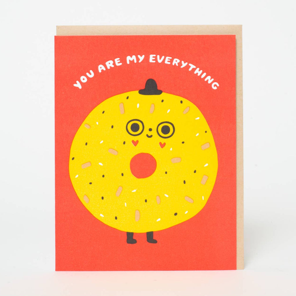 Show someone they're your everything with this quirky letterpress greeting card by Suzy Ultman. Featuring a delicious bagel design and a playful message, it's a perfect way to express your love and humor all in one. Send a smile (and some carbs) to a loved one today!