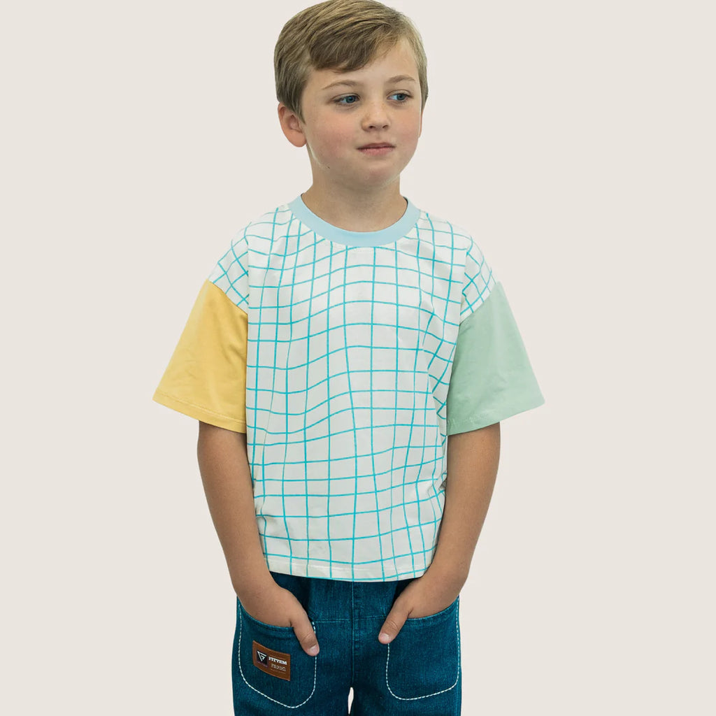 Our unique tee is crafted from a sublime blend of 95% cotton and 5% spandex, making it the perfect companion for your child's everyday adventures. The shirt’s relaxing ivory and calming blue checkered pattern is contrasted with sunny yellow and vibrant green sleeves, creating a kaleidoscope of colors that mirror the joys of childhood.