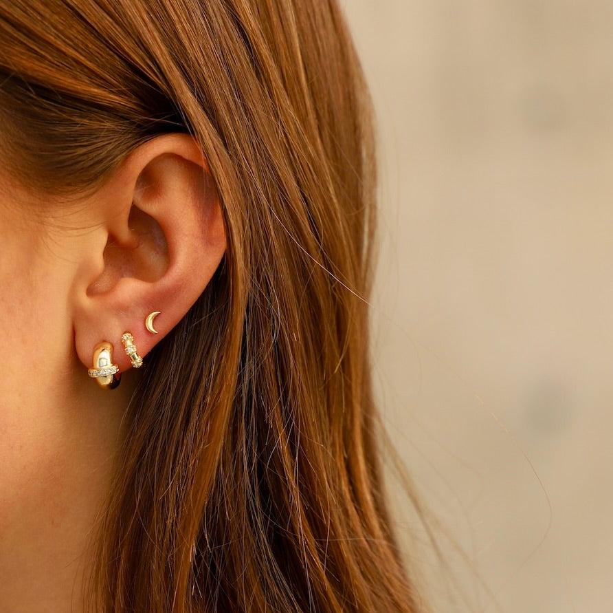 These mini half moon studs are the perfect accessory for any outfit, combining simplicity and sophistication. Featuring a crescent moon design, these add a touch of celestial charm to your everyday style