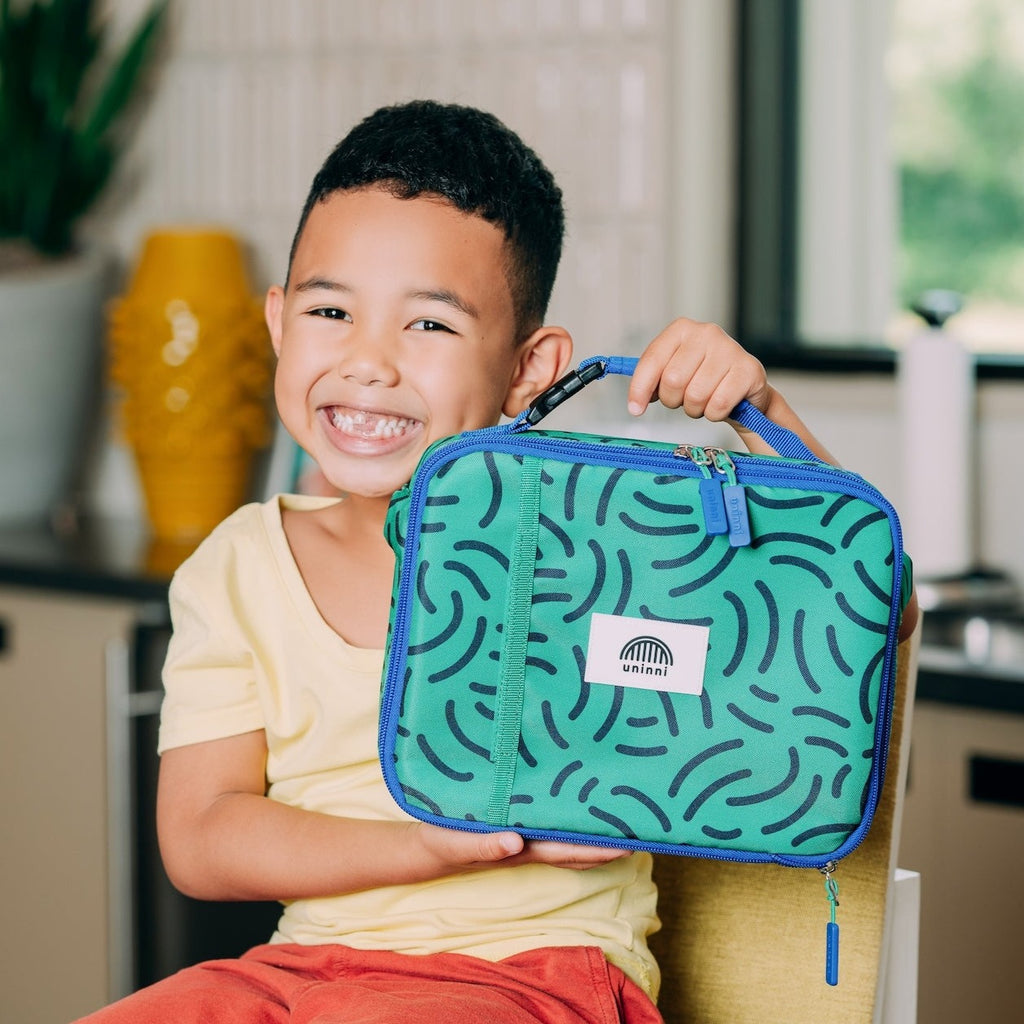 Take flight with the Ellis Lunch Bag in Brush Strokes! This unique lunch bag features a playful brush strokes design, perfect for kids or anyone with a sense of adventure. Keep your lunch fresh and cool while showing off your fun personality.