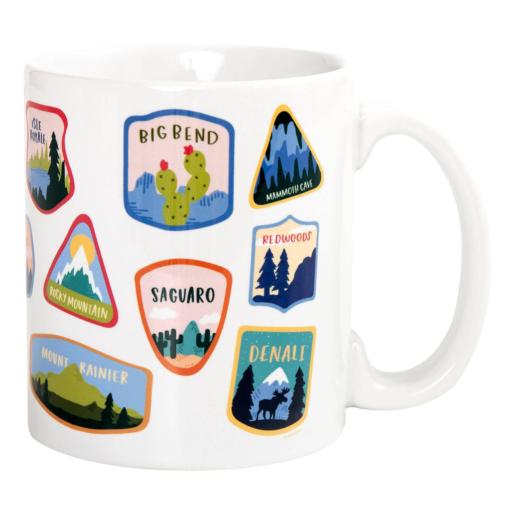 Embark on a sip-worthy journey with our National Parks Postage Stamps Mug. Perfect for coffee, tea, or sparkling water, this drinkware is an excellent gift for nature lovers, travel enthusiasts, and fans of America's national treasures. This cup features hand-drawn postage-style icons of parks including Olympic, Grand Teton, Glacier, Redwoods, Denali, Joshua Tree, Bryce Canyon, Grand Canyon, Yellowstone, Rocky Mountain, Everglades, Badlands, Hawaii Volcanoes, Big Bend, Great Smoky Mountain, Acadia and more!