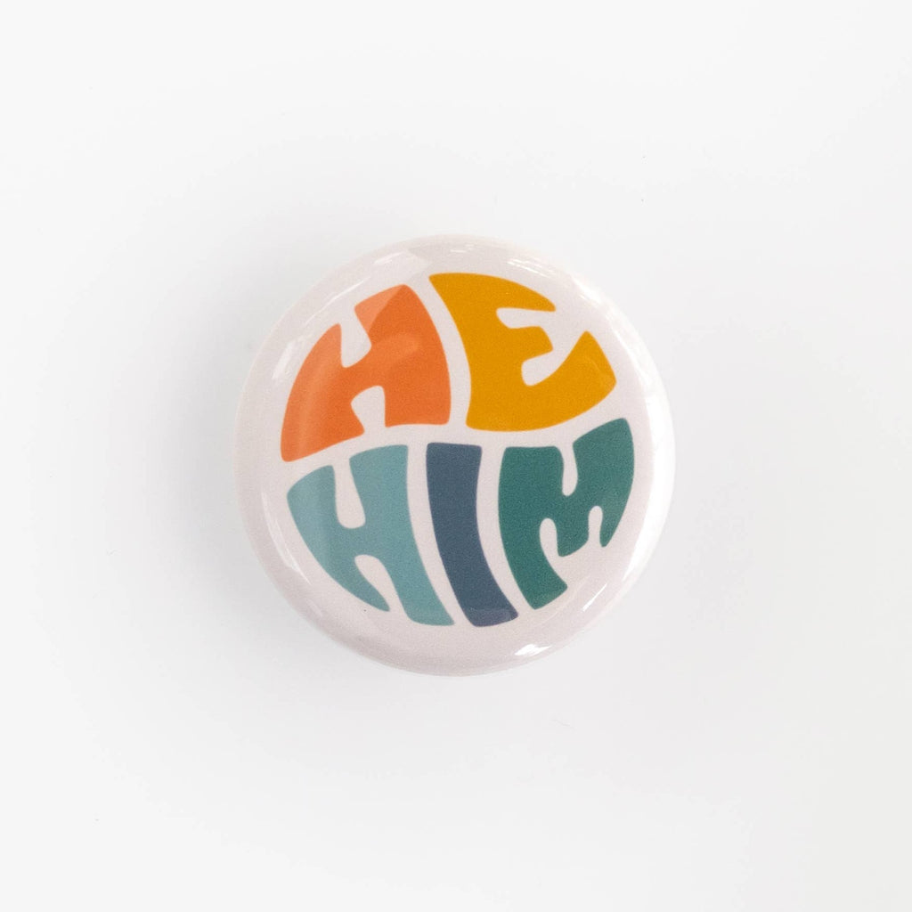 Wear your pronouns with pride with these cute retro-style buttons! This pinback button displays "He/Him" pronouns in a colorful palette. It is the perfect way to let others know how to address you and to show your support for the LGBTQ+ community!  Size: 1.25" pinback button