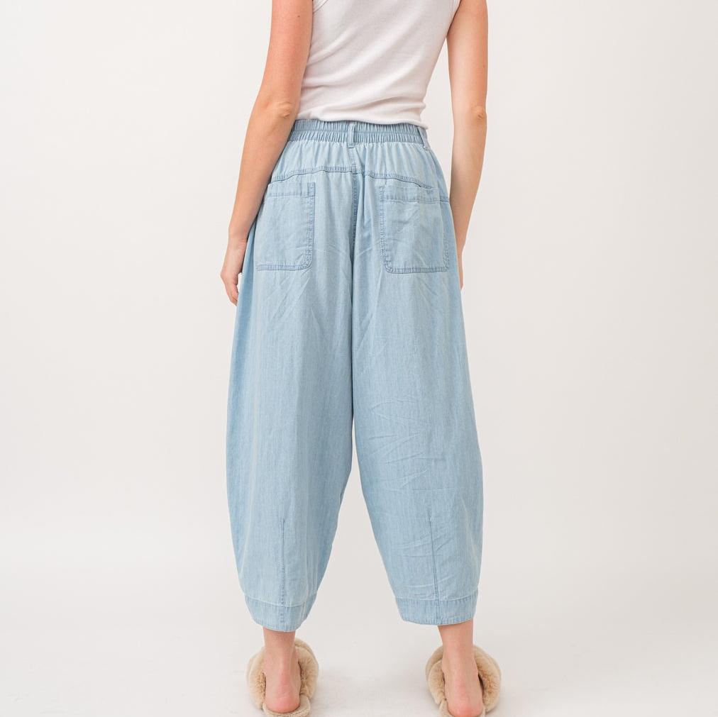 Quinn Pants are crafted from lightweight denim, offering a relaxed fit with a pleated front detail for added flair. The elastic back waist ensures comfort without compromising style.