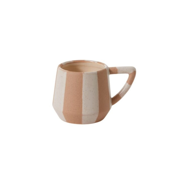 Make morning coffee is even more special with the artful design of the striped ceramic Botera Mug. Featuring a food-safe finish on top of a textural ground speckled white glaze, this neutral, minimalist piece stands out among dinnerware with its unique geometric handle tapered base. We recommend hand washing to protect finish.