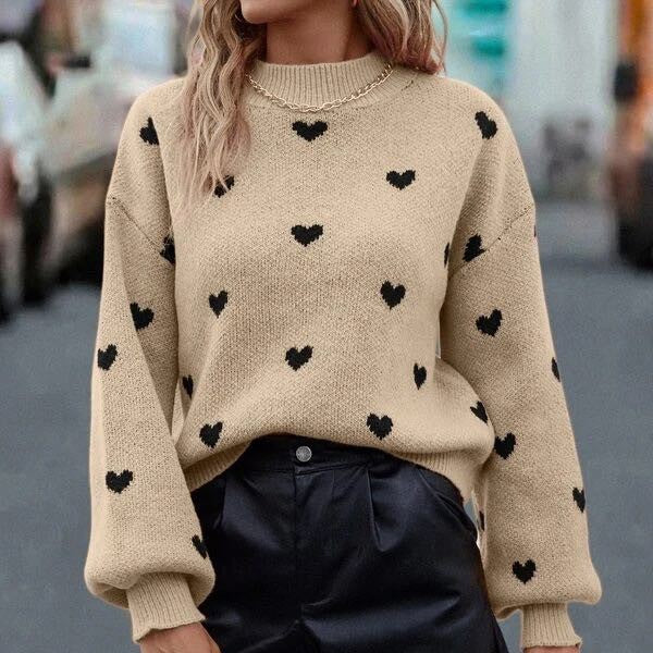 Fall in love with our All Over Heart Sweater in tan, featuring a playful black heart pattern.