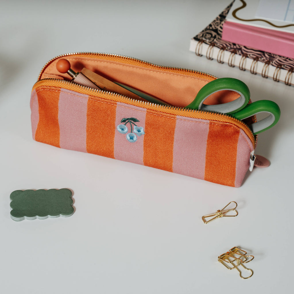 Keep all your paper tools in one place with this Papier pencil case. With a chic striped pattern and a cherry flower motif, it’s bound to brighten your days. Perfect for carrying your creativity with you, whether you’re at your desk or on the move.