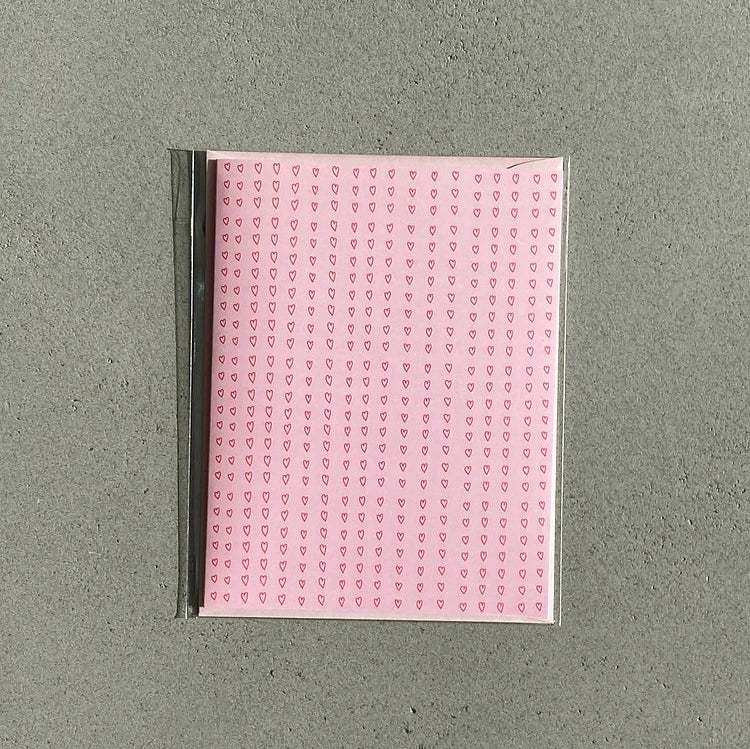 pink card covered in tiny red hearts