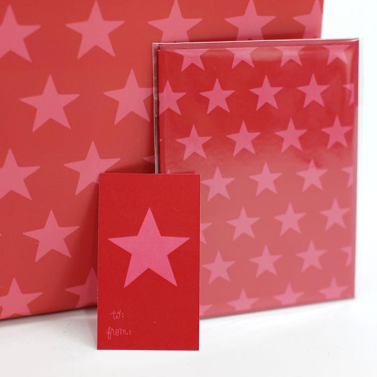 red gift tag featuring a bright pink star with a matching card and wrapping paper