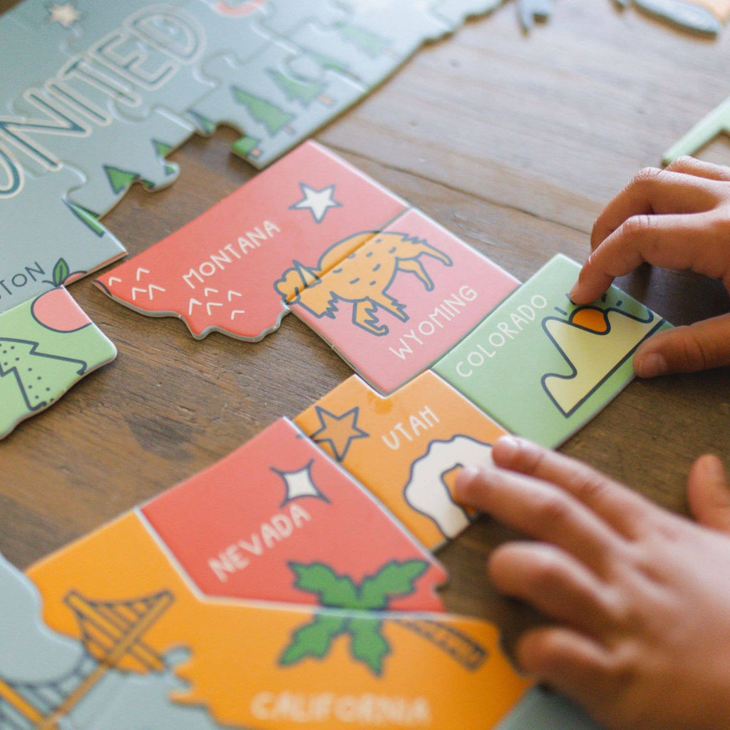 Explore the United States of America with our one-of-a-kind, hand-drawn puzzle. The uniquely state-shaped pieces and beautifully illustrated designs make this puzzle a fun and educational activity for kids and adults alike. With only 110 pieces, it's the perfect gift for children and a great addition to any teacher's classroom.