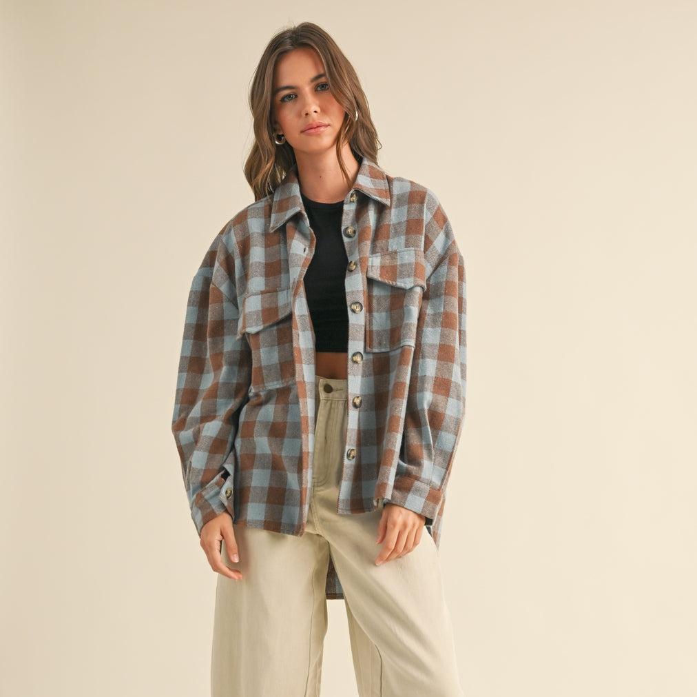 Introducing our Buffalo Check Shacket in Blue, a perfect mix of style and comfort. This quirky shacket (shirt + jacket) features a playful gingham pattern, adding a touch of fun to any outfit. Stay effortlessly cool and casual with this must-have piece.