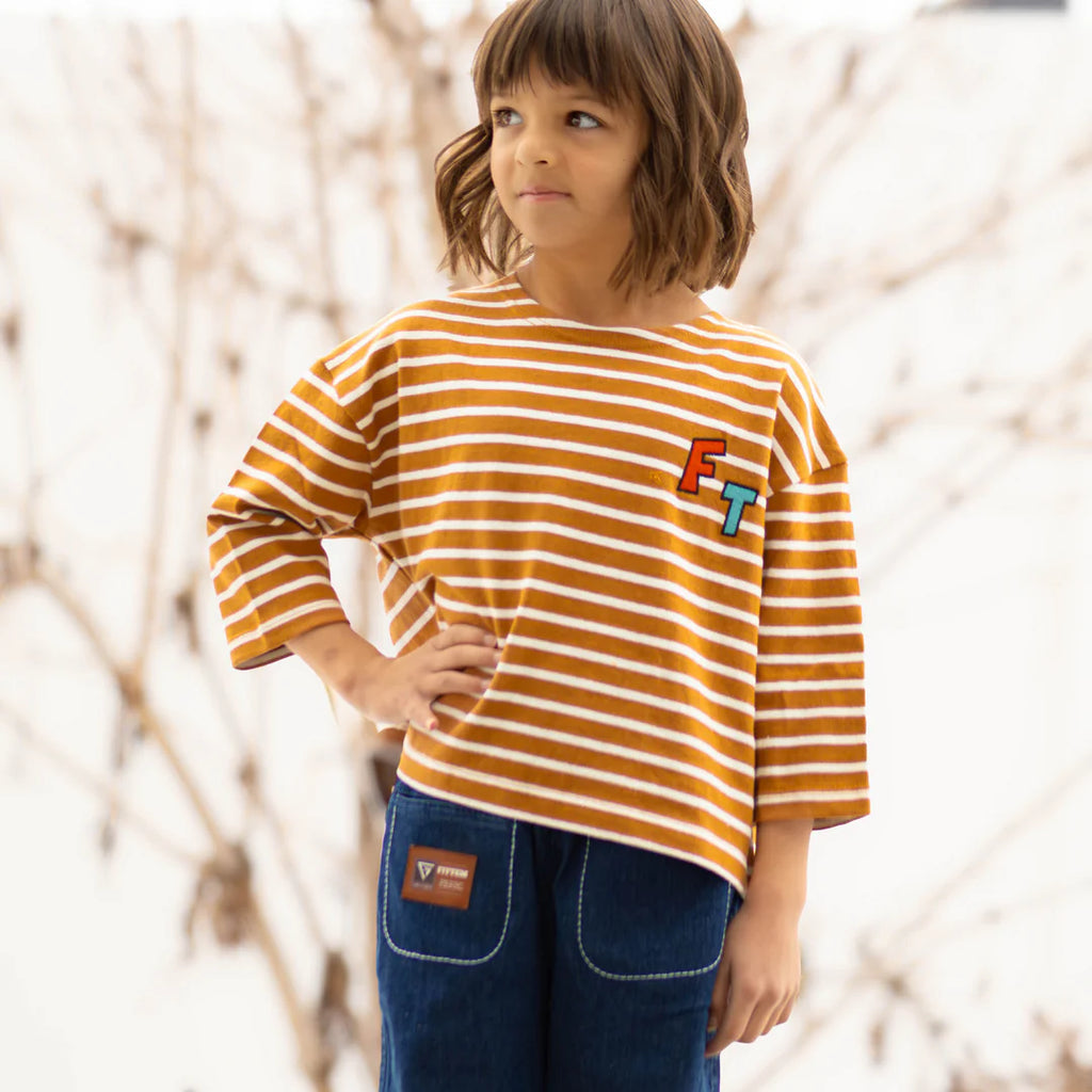 "Introducing our FITTEM Striped Overfit 3/4 Sleeve Tee—a versatile, comfortable staple every child's wardrobe needs. Designed to set a new standard in comfort and style, this tee is perfect for both boys and girls who seek the freedom to explore, play, and imagine.