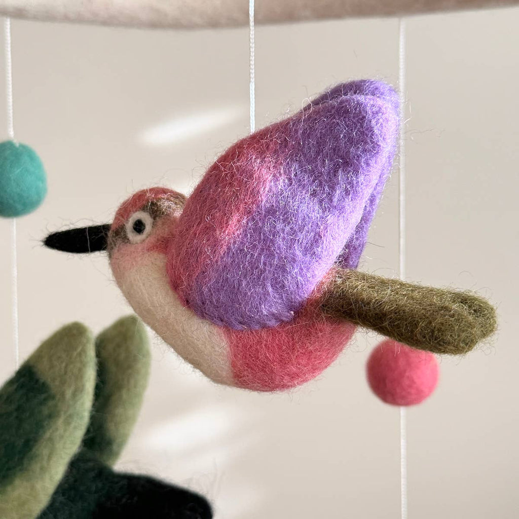 Discover our vibrant Hummingbird Baby Mobile!  Five colorful hummingbirds with dynamic wing positions dance around a white felt frame. Add a pop of brilliance and wonder to your space. A must-have for bird lovers, bringing nature's beauty right to your baby's eyes. Let imagination take flight!