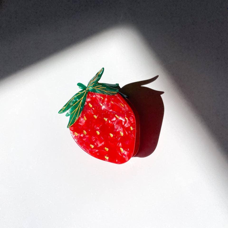 Our strawberry claw is hand painted by our Solar Eclipse artists. Carefully crafted from cellulose acetate, an eco-friendly, biodegradable material made from recycled wood pulp. The claw is double sided, for a perfect look from all angles!