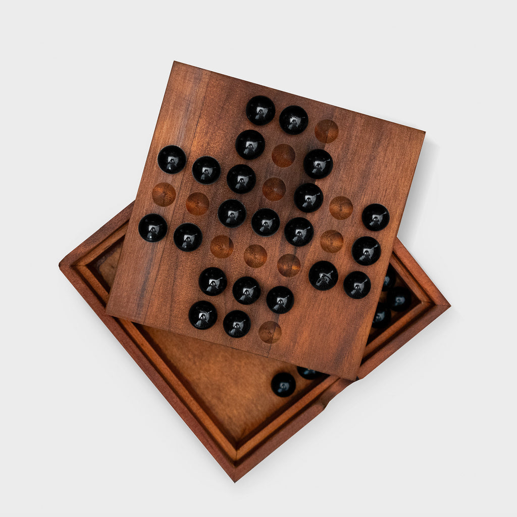 Solo Noble or Solitaire is an ancient and classic board game for one player. This deluxe wooden set includes 33 black glass marbles, the storage box lid doubles as the playing board. Solitaire is a hard to solve puzzle, with one aim, and many possible solutions. We have also included instructions for lesser known variations. Solving these easier variants will set you on the road to the ultimate solution