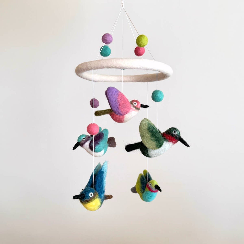 Discover our vibrant Hummingbird Baby Mobile!  Five colorful hummingbirds with dynamic wing positions dance around a white felt frame. Add a pop of brilliance and wonder to your space. A must-have for bird lovers, bringing nature's beauty right to your baby's eyes. Let imagination take flight!