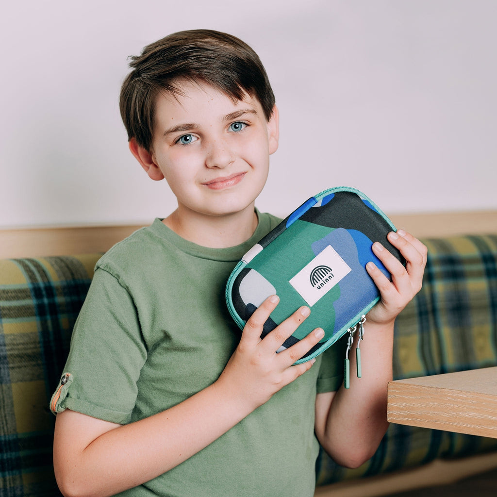 Keep your writing tools organized and stylish with the Arden Pencil Case in Camo Kid Blue/Green design. This quirky and playful case adds a touch of fun while holding all your pencils, pens, and markers in place. Say goodbye to chaotic desks and hello to a minty fresh workspace.