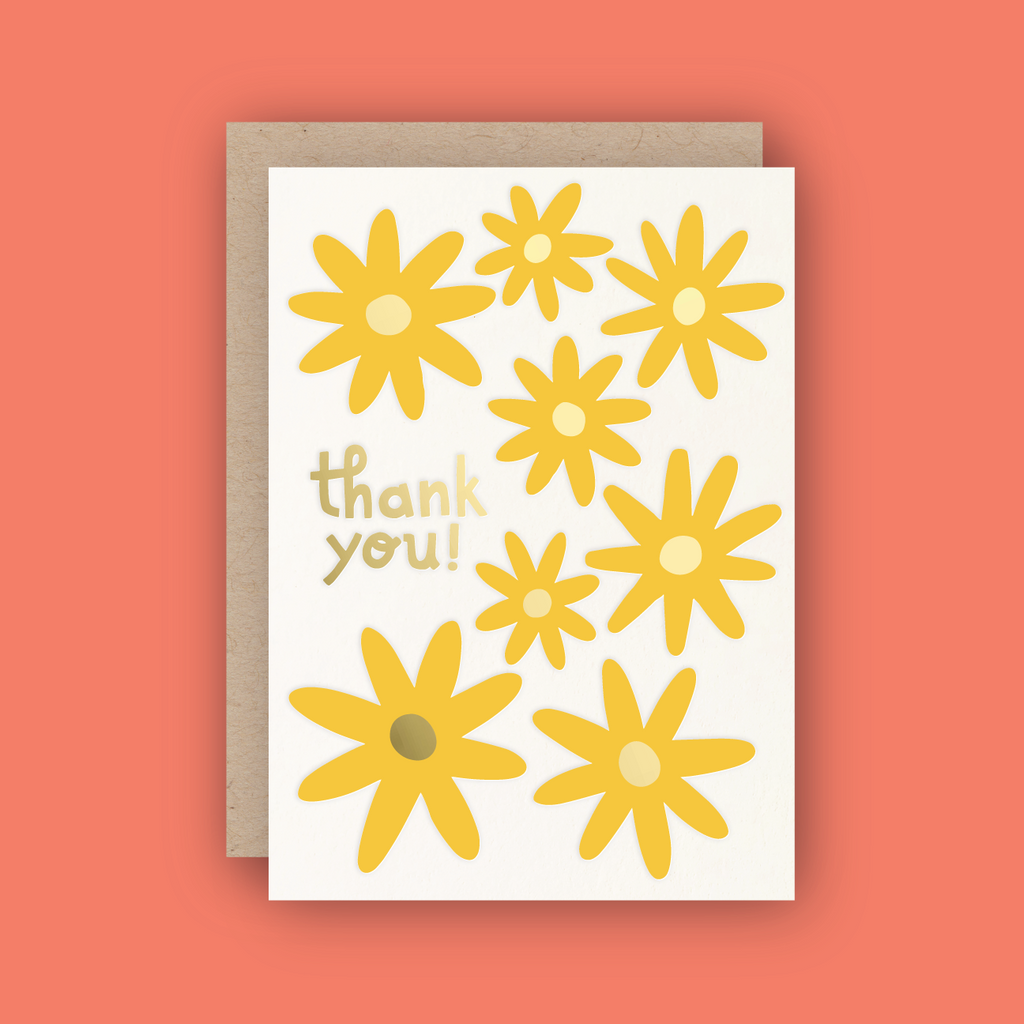 white card reading "thank you!" with yellow and gold foiled daisies