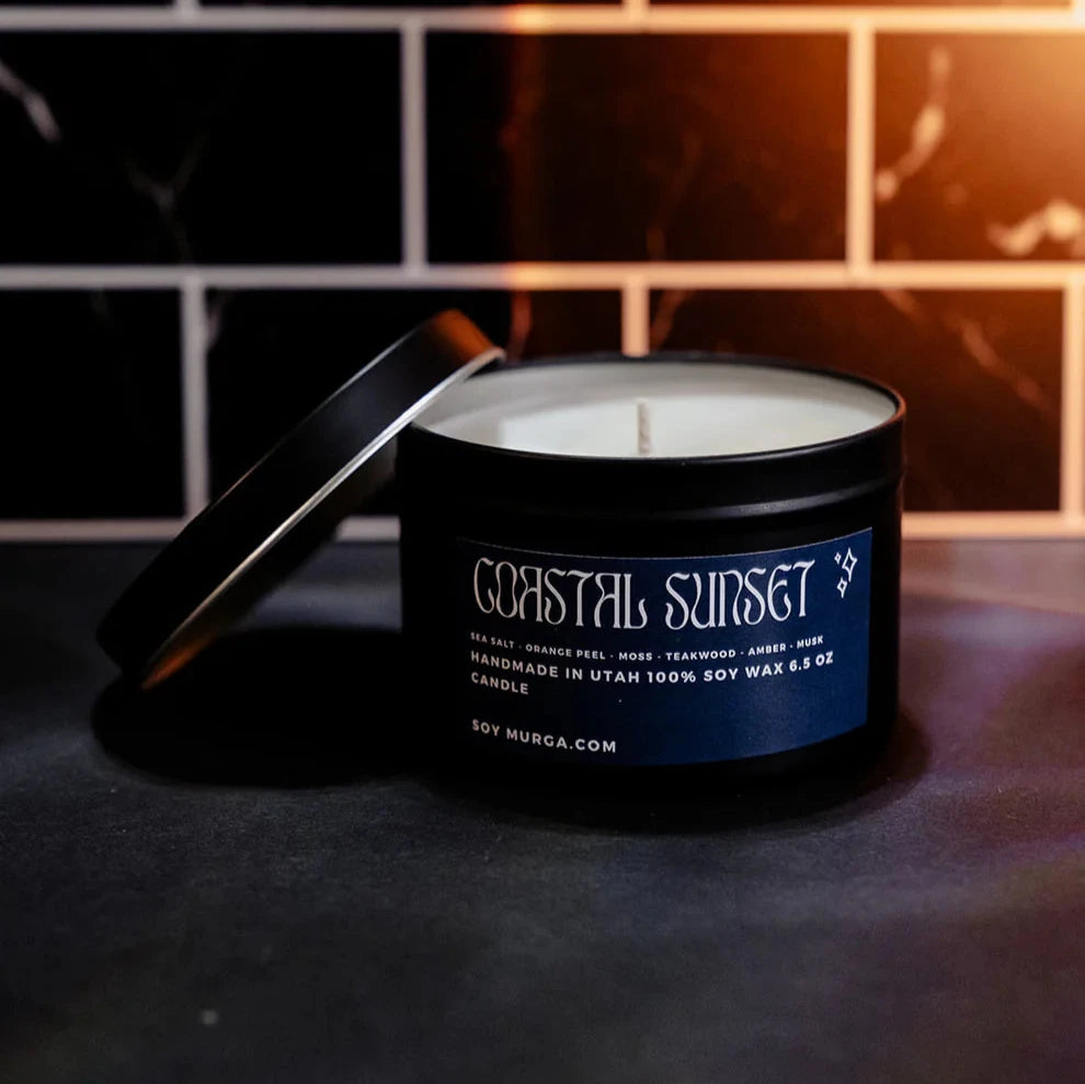 6.5 oz coastal sunset soy candle hand poured in a matte black tin 