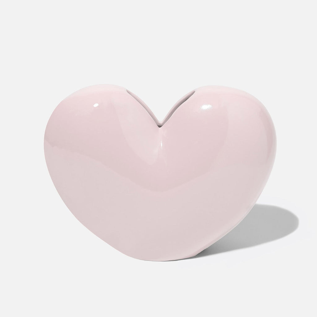 "Fall in love with your decor with our Pink Heart Ceramic Vase. This quirky, playful vase is the perfect addition for adding a touch of love and personality to any room. Its pink heart design and ceramic material make it a unique and charming piece."