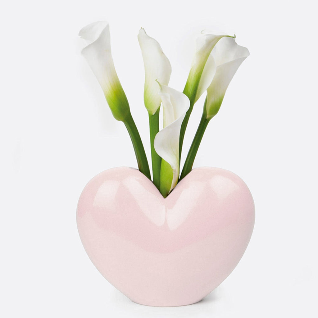 "Fall in love with your decor with our Pink Heart Ceramic Vase. This quirky, playful vase is the perfect addition for adding a touch of love and personality to any room. Its pink heart design and ceramic material make it a unique and charming piece."