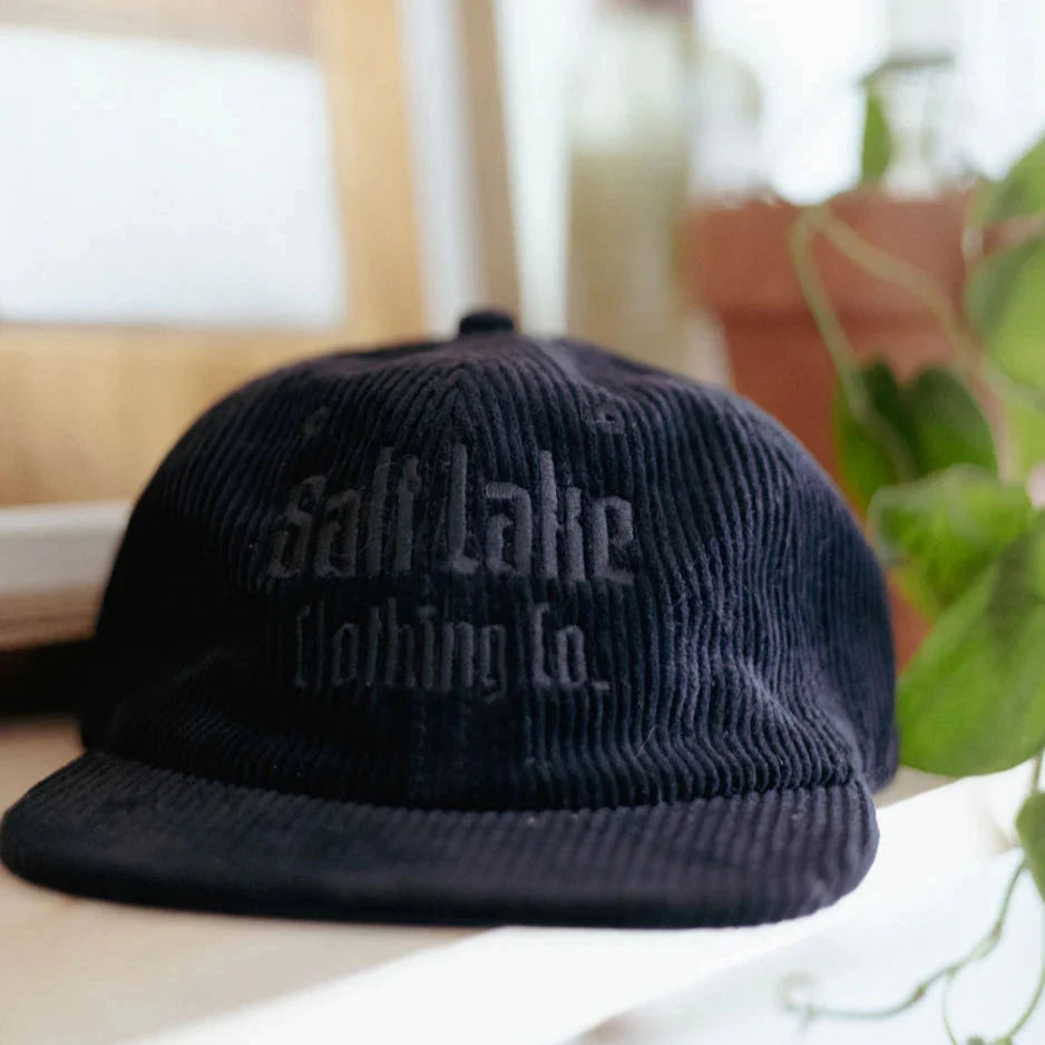 Black corduroy cap with salt lake clothing co logo