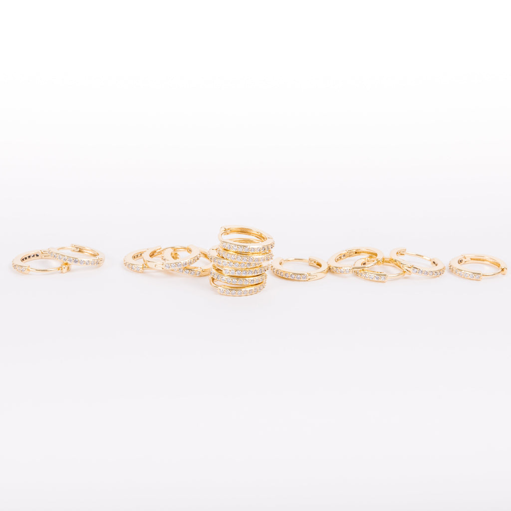 Our gold diamond huggies have been our bestselling earring for over a year, and it's no wonder.&nbsp; With a stunning and classic design, these earrings go with EV. ERY. THING.&nbsp; They are both timeless and on trend.&nbsp; Their&nbsp;unique click in click out clasp&nbsp;allows you to&nbsp;leave them in day and night without any discomfort.&nbsp;