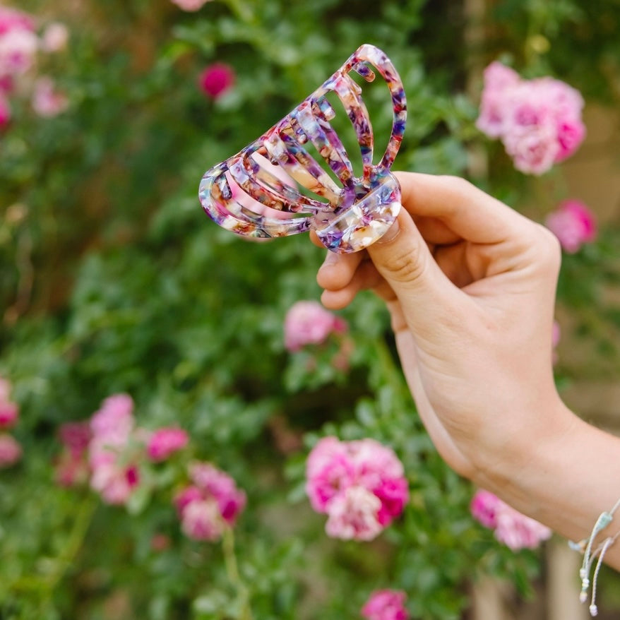 Introducing the Carlisle Claw Clip - the perfect accessory for any trendsetter! With a bold marble pattern featuring shades of purple, blue, and cream, this clip will add a pop of color to any hairstyle. Upgrade your look with this fun and unique hair accessory.