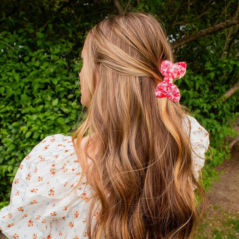 Introducing the Dreamland Bow Claw Clip - the perfect accessory for any hairdo! With its vibrant red and white marble pattern and classic bow claw clip design, this hair clip will add a touch of fun and style to your outfit. Effortlessly elevate your look with the Dreamland Bow Claw Clip!