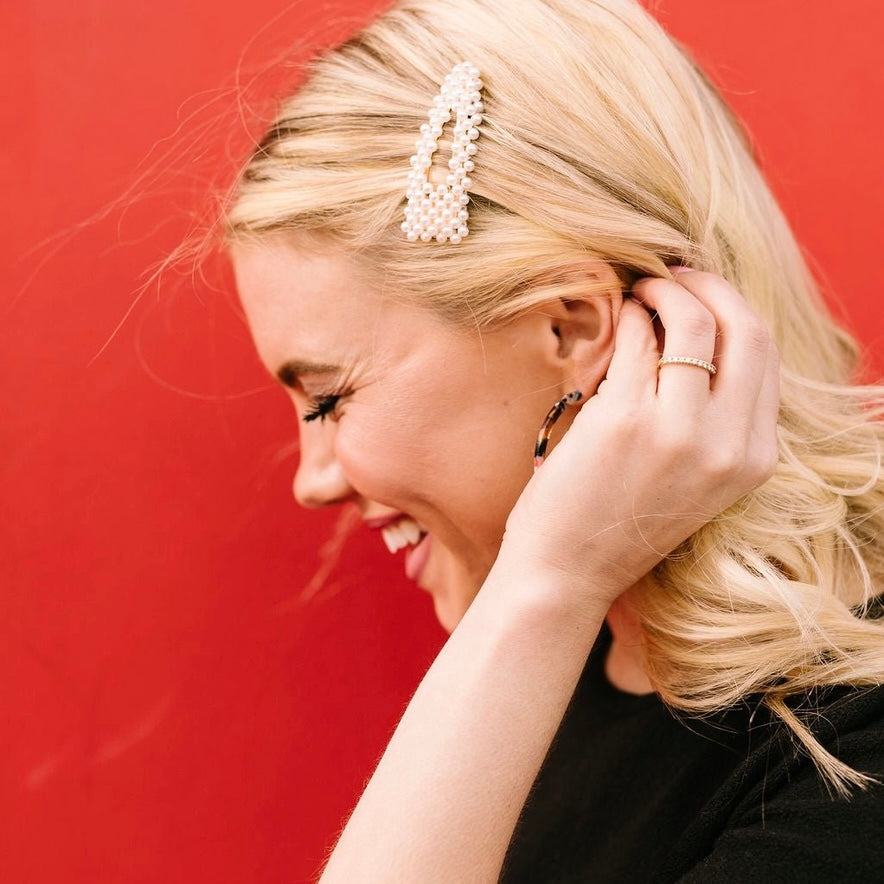 Upgrade your hair accessories with our Pearl Snap Clip! This elegant snap clip is covered in pearls, adding a touch of sophistication to any hairstyle.