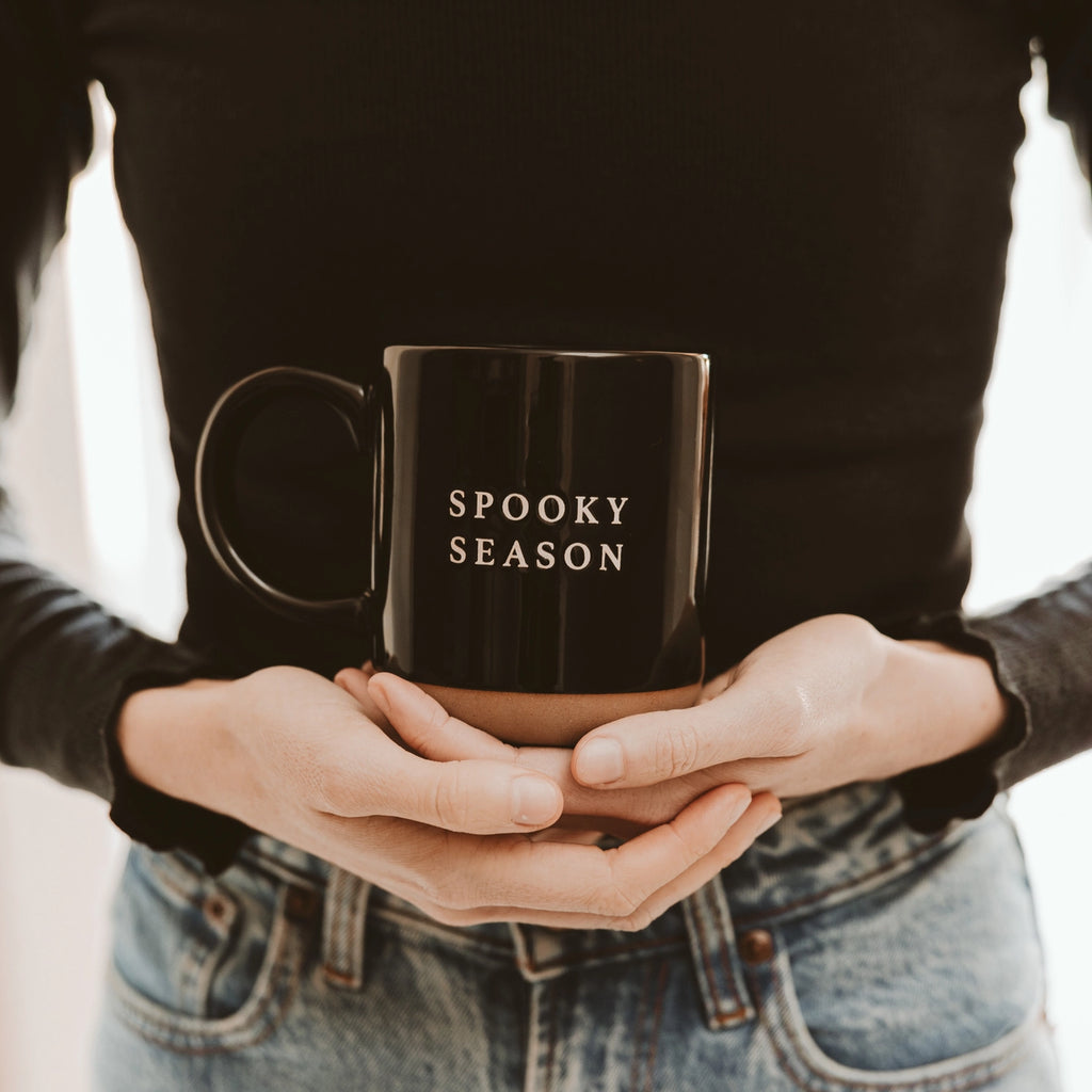 Get in the spirit of "spooky season" with this black stoneware coffee mug featuring cozy white lettering. Perfect for sipping your favorite brew while enjoying all the frightful fun!