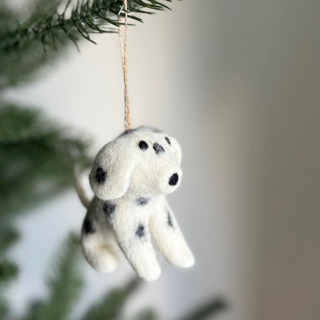 Get ready to have a barking good time with this Felt Dalmatian holiday Ornament! Created with needle felting and wet felting techniques, this playful pup features a sitting position, black spots, and intricate details. It's so lifelike, you might do a double take (or double bark)!