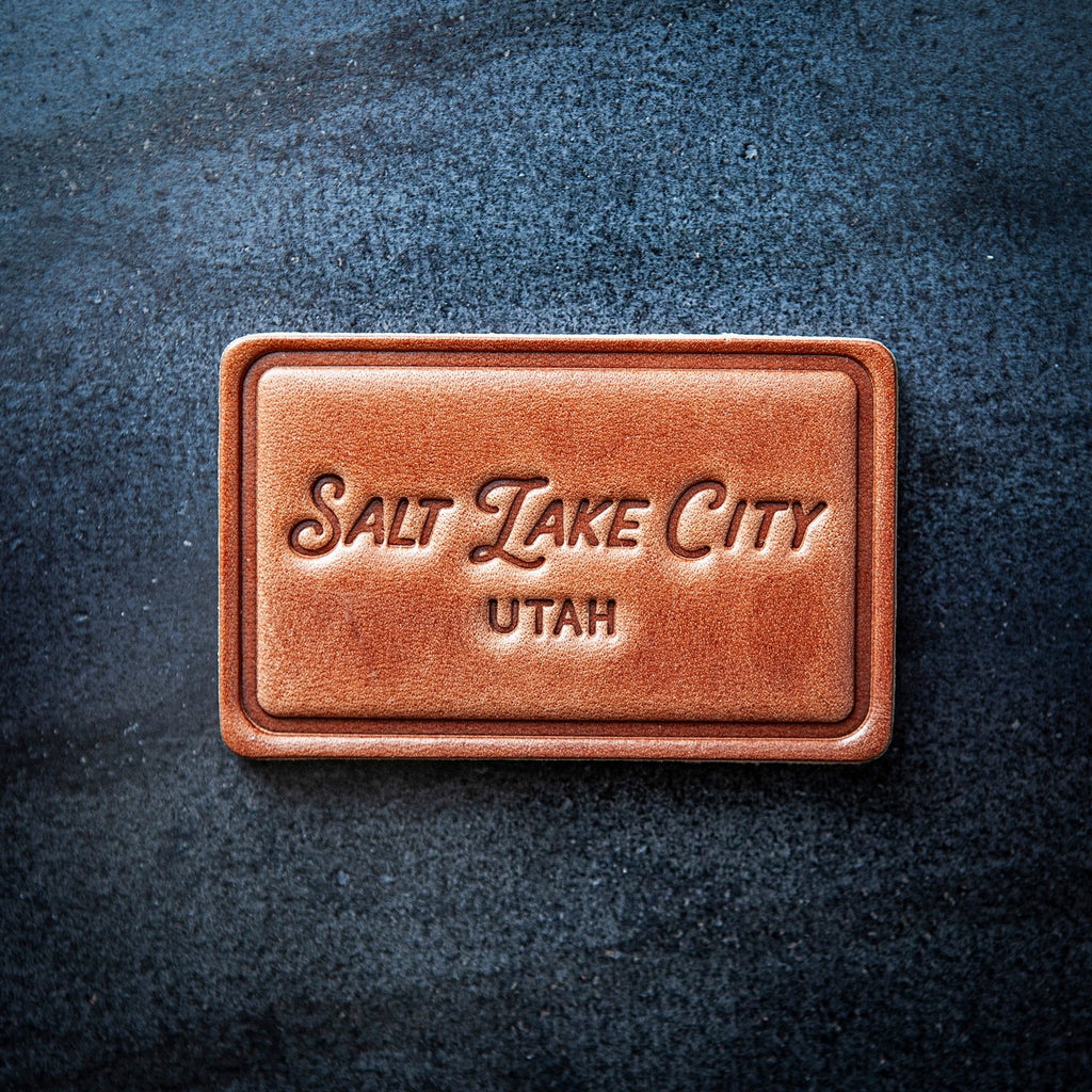 This leather magnet comes in a block style featuring “Salt Lake City, Utah” in beautiful calligraphy. Our leather magnets are cut and embossed from some of the thickest and finest harness leather available, and patina beautifully as they age.

Size: 2.8” x 1.75”

Magnet: Neodymium