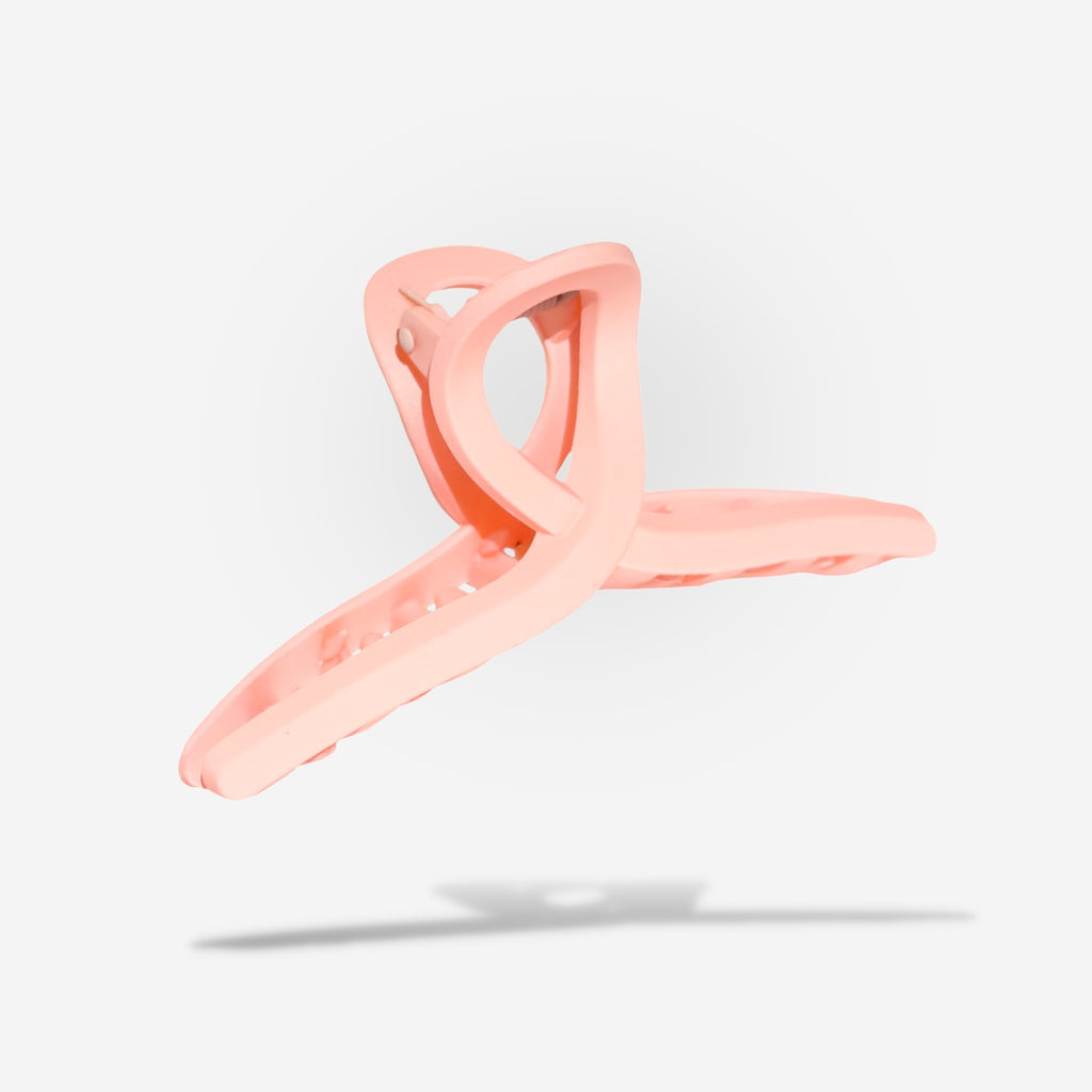 Looking to change up your style? Our Matte Loop Hair Claw is the perfect way to do it! With its unique loop design and soft pink matte color, this claw is a stylish way to add some flair to your look. Upgrade your hair game today!