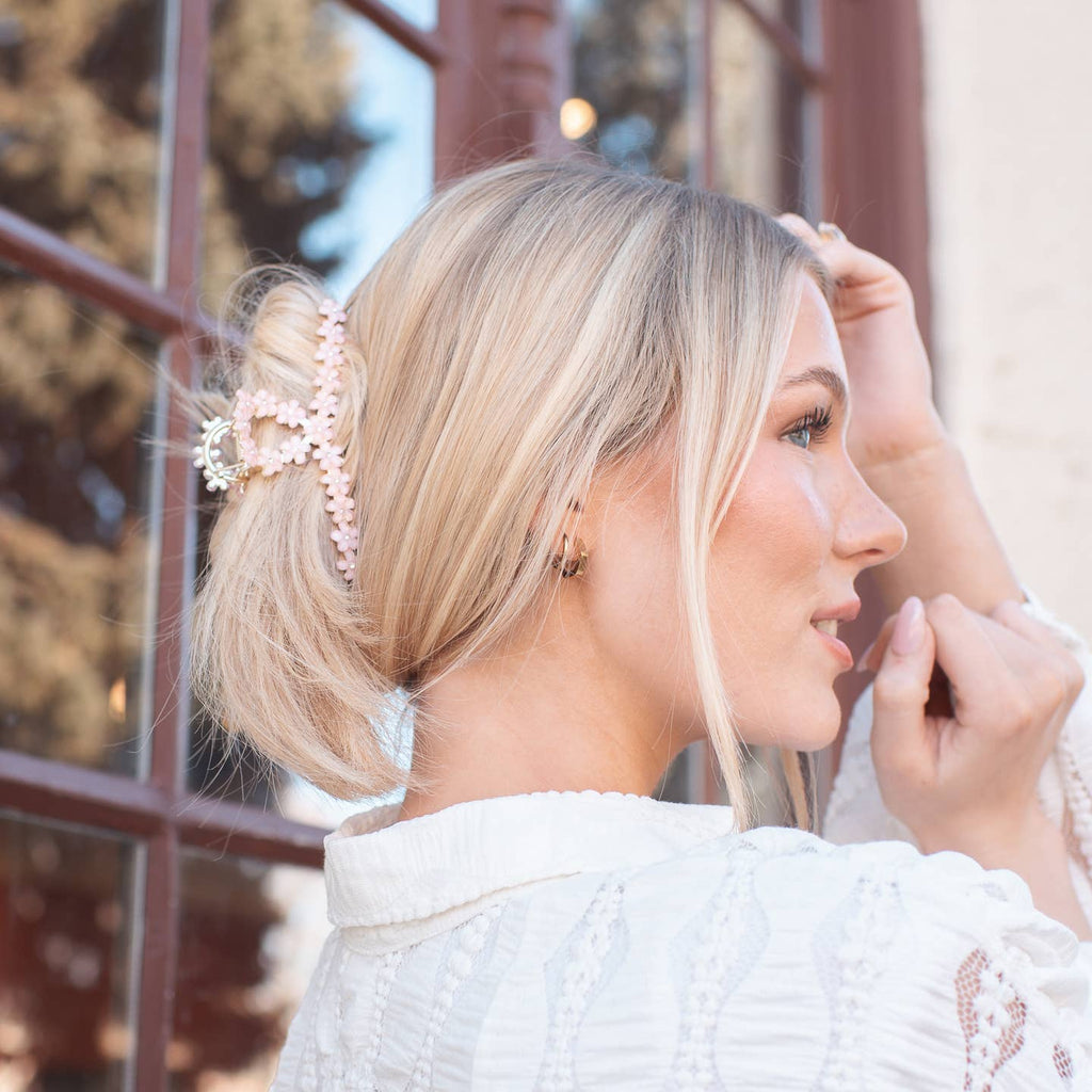 This Pink Cherry Blossom Hair Claw Clip is both elegant and delicate, featuring a beautiful cherry blossom design and a pop of pink crystal. With this accessory, you can add a touch of charm and whimsy to any hairstyle!