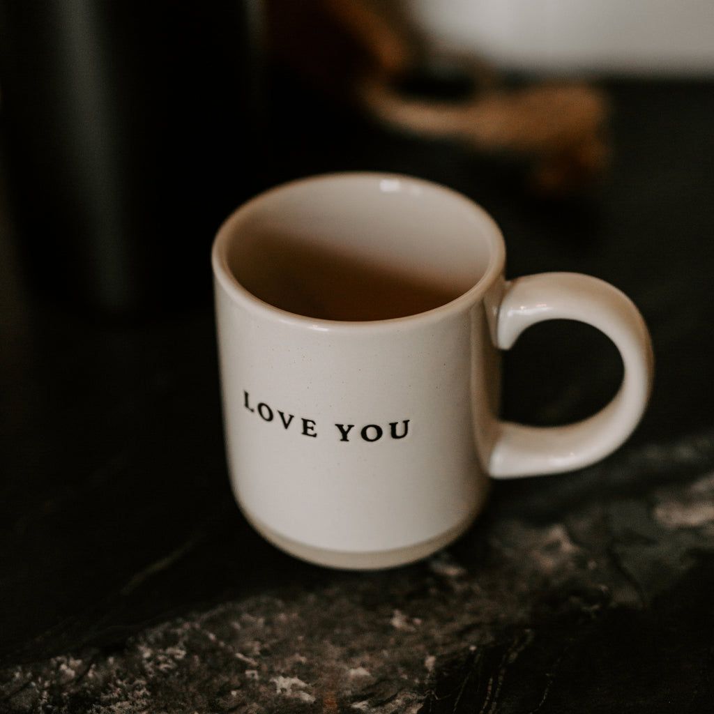 Indulge in your morning ritual with our Love You Stoneware Coffee Mug. Adorned with a heartfelt "Love you" message and crafted from cozy stoneware, this mug will quickly become a cherished part of your daily routine. With its natural colors and elegant black lettering, it adds a touch of sophistication to your kitchen decor. Sip your favorite brew in style and show your love at the same time.