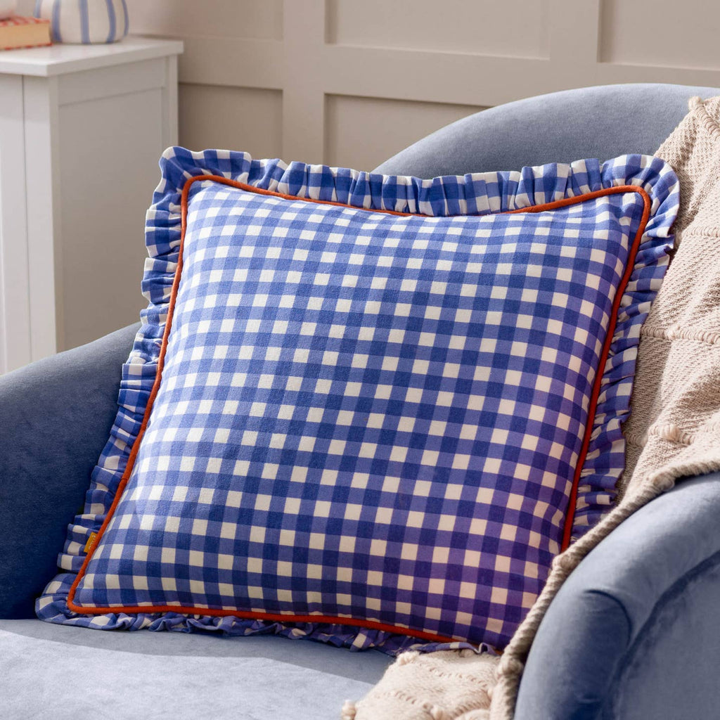 Celebrating traditional designs with an on-trend twist, the Maude Gingham cushion is a standout piece that is ideal for the summer months. With a check pattern coming in summer-y colours, this design boasts both a piped and frilled trim, which finishes the design superbly. A seasonal delight to place on your sofa during those long, hot sunny days. Complete with a dual-sided design and hidden zip fastening. Made of super soft, 100% cotton fabric.