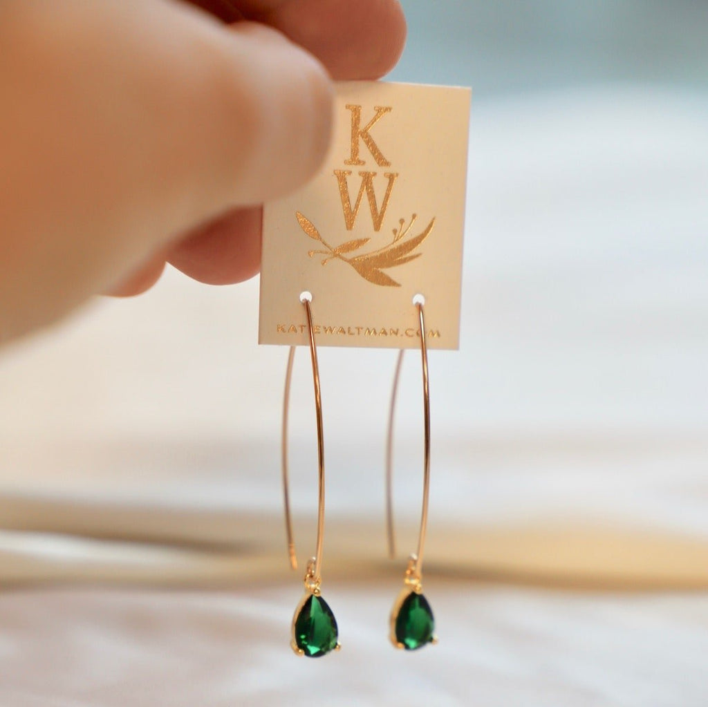 Featuring gold threader earrings and a stunning emerald teardrop drop, our Emerald Teardrop Earrings are the epitome of elegance. Elevate any outfit with these timeless and luxurious earrings, perfect for any occasion. Add a touch of sophistication to your jewelry collection with these beautiful earrings.