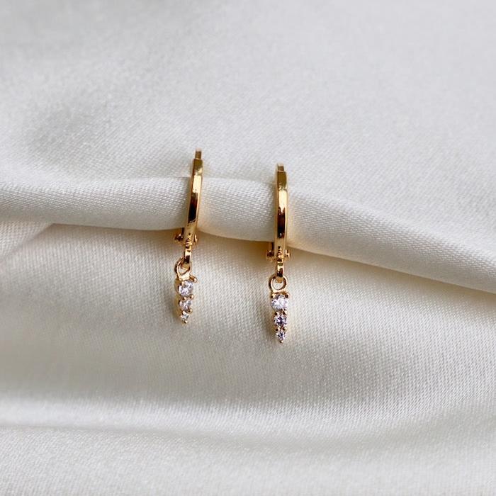 We are in love with all our huggie styles! This CZ Stack Trio Huggie&nbsp;is the perfect addition for those who want something really simple to their hoop or are looking for an elevated look to an amazing ear stack! The cubic zirconia adds the perfect amount of shimmer to any look!