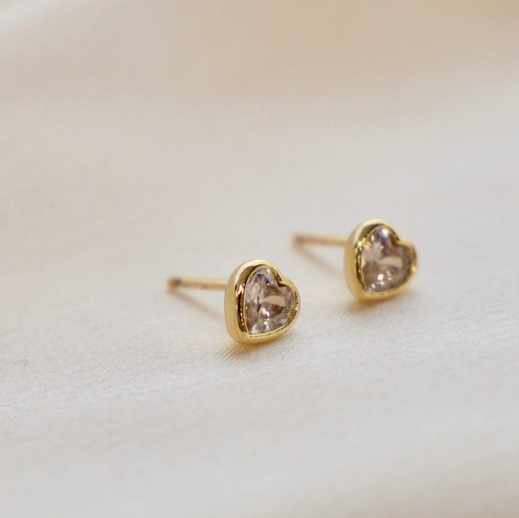 These CZ heart stud earrings are a stunning addition to any outfit. Made with high-quality cubic zirconia, they offer the perfect sparkle without breaking the bank. The classic heart shape adds a touch of romance to your look. Elevate your style with these elegant and versatile earrings.