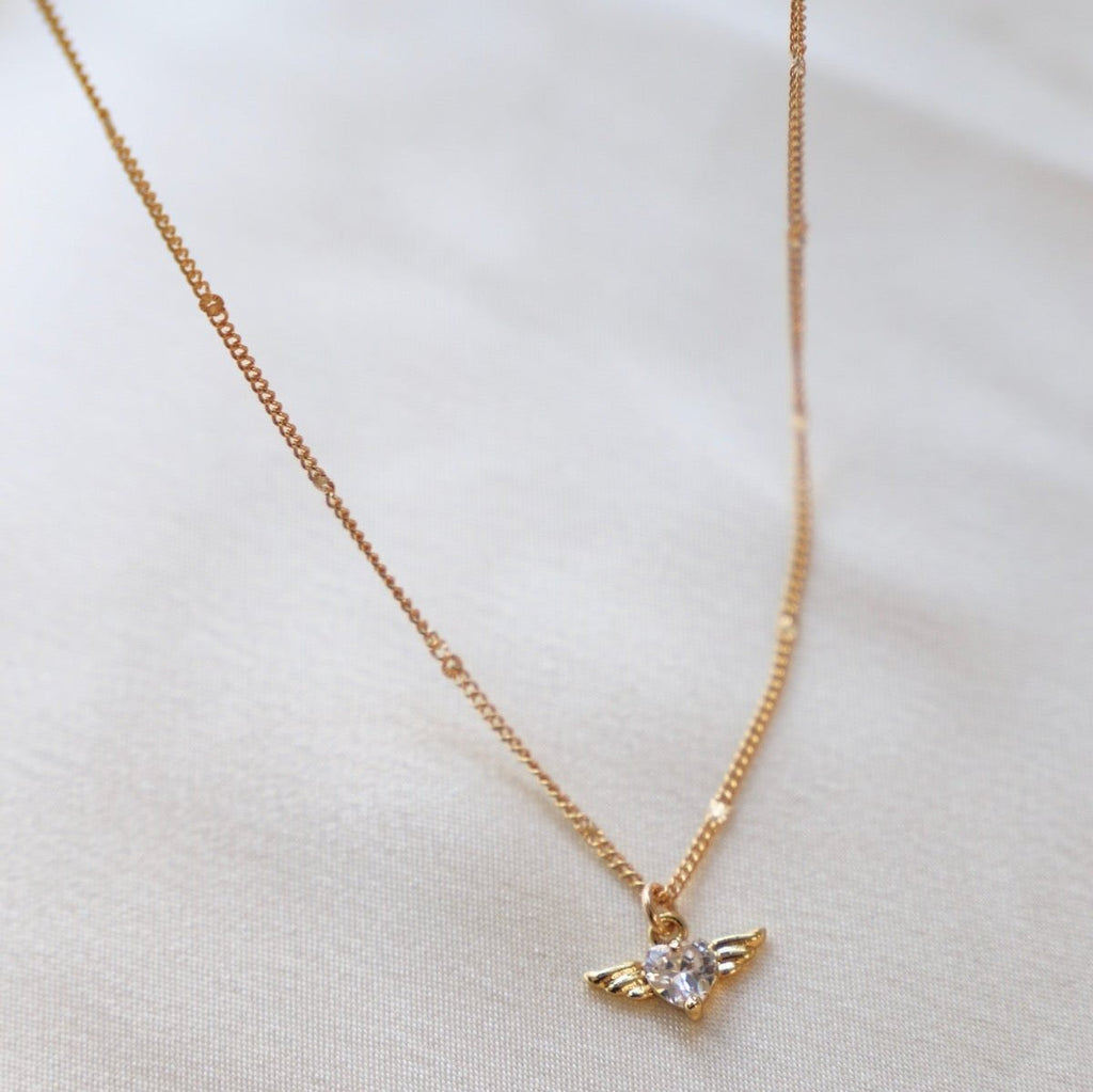 Add a little sparkle to your day with this All For You Necklace - featuring a shiny CZ heart with gold wings soaring on our new gold filled sunburst curb chain! 16" chain