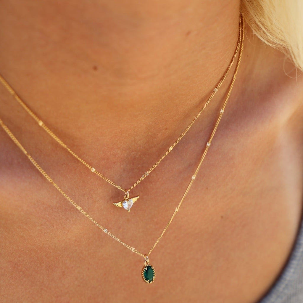 Add a little sparkle to your day with this All For You Necklace - featuring a shiny CZ heart with gold wings soaring on our new gold filled sunburst curb chain! 16" chain