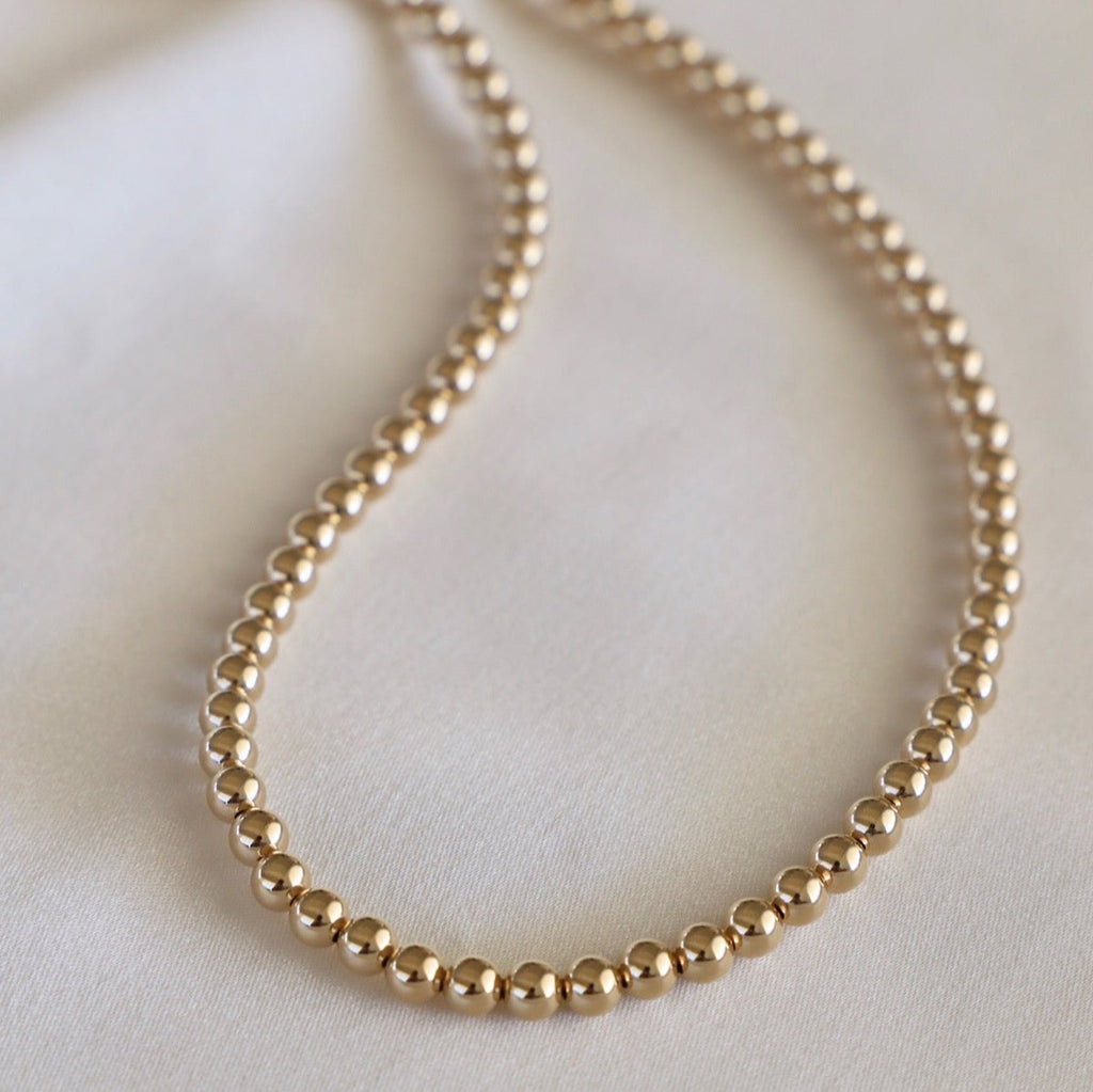 Sprinkle some sparkle into your wardrobe with our Gold Filled 5MM Beaded Necklace. This dazzling piece will add a touch of elegance to any outfit, perfect for both casual and formal occasions. Shine bright like a diamond with this must-have accessory!