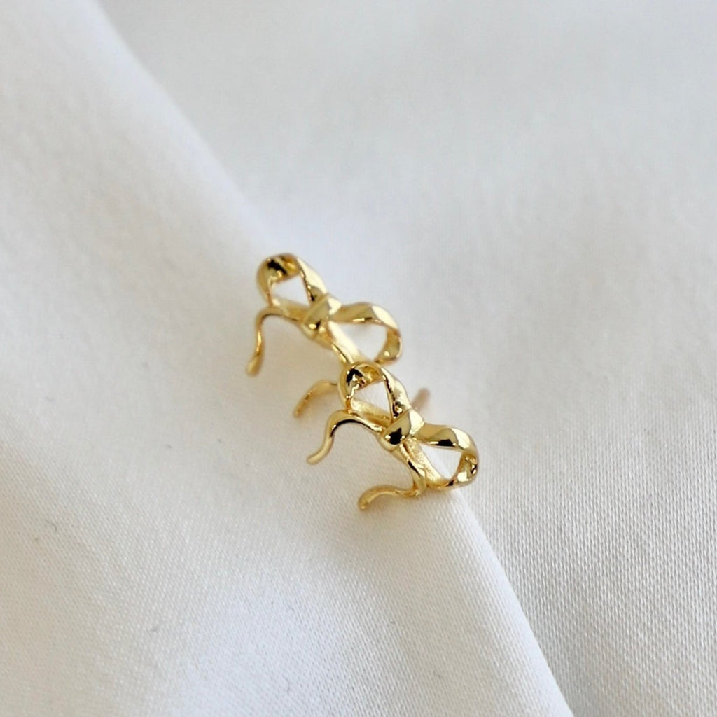 Effortlessly elevate any outfit with our Golden Bow Studs. These delicate gold plate bow studs add a touch of elegance and sophistication to your look. Crafted with precision and attention to detail, they are a must-have accessory for any fashion-forward individual. Add a golden touch to your wardrobe with these timeless studs.