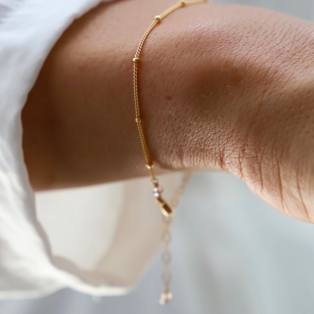 This dainty bracelet features a petite ball chain, perfect for adding a delicate touch to any outfit. Its lightweight design ensures comfortable wear, while its versatile style makes it suitable for any occasion. Dress it up or down for a touch of subtle elegance.