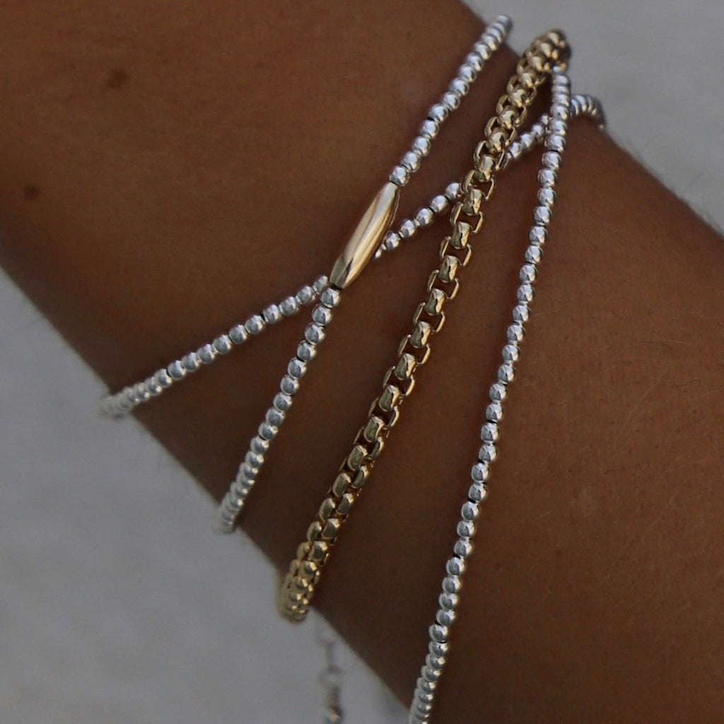 The Miniature Roman Bracelet features a unique combination of silver beaded links and a gold accent oval. Crafted with high quality materials, this chic bracelet is perfect for accessorizing an outfit and adding a touch of sparkle