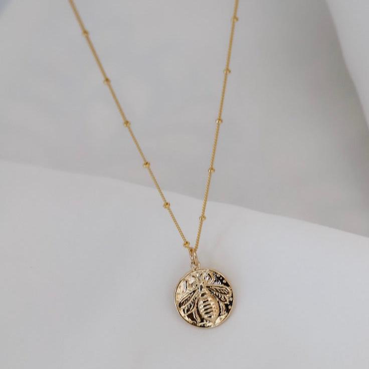 Medallion necklaces are one of our favorite looks. This vintage bee medallion pairs perfectly with our delicate satellite chain for a look that won't go out of style