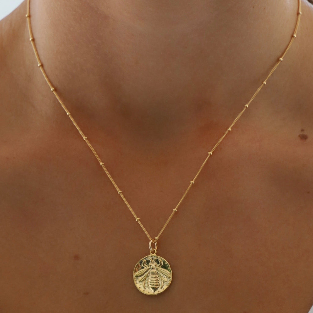 Medallion necklaces are one of our favorite looks. This vintage bee medallion pairs perfectly with our delicate satellite chain for a look that won't go out of style