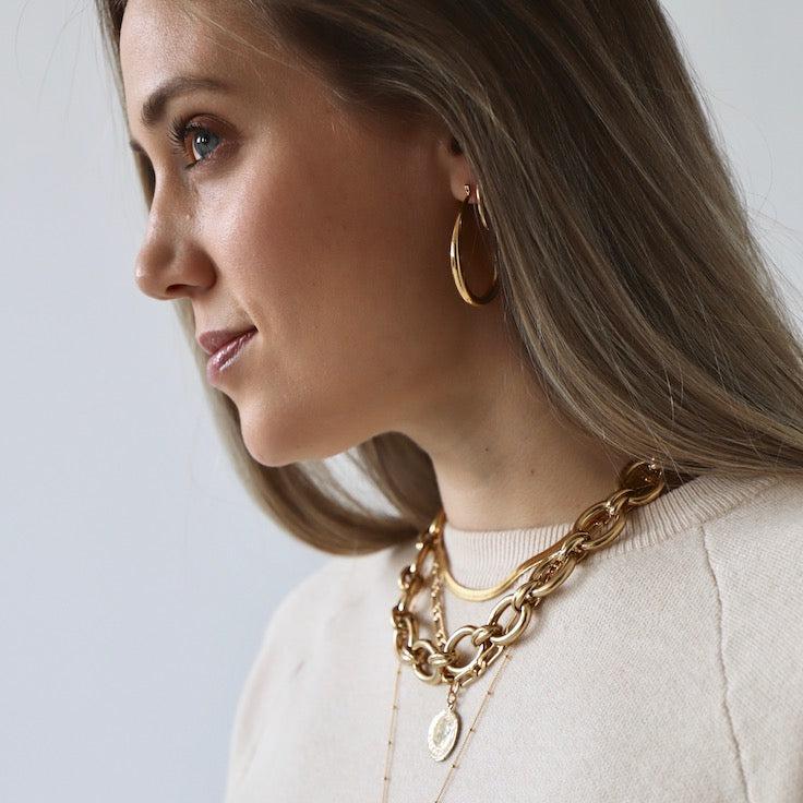 Add a touch of whimsy to your wardrobe with our Large Teadrop Hoop Earrings! These earrings feature a unique teardrop shape that adds a playful twist to any outfit. Lightweight and versatile, they're perfect for everyday wear or a night out on the town. Don't miss out on this one-of-a-kind accessory! Gold